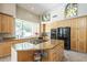 Spacious kitchen with granite island, modern appliances, and ample natural light from a large window at 11651 E Appaloosa Pl, Scottsdale, AZ 85259