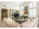 Bright and open living room with built-in shelving and large windows overlooking the backyard at 11651 E Appaloosa Pl, Scottsdale, AZ 85259