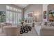 Bright living room featuring vaulted ceilings, plantation shutters, neutral decor and large windows at 11651 E Appaloosa Pl, Scottsdale, AZ 85259