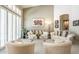 Cozy living room featuring comfortable seating, stylish art, and ample natural light at 11651 E Appaloosa Pl, Scottsdale, AZ 85259