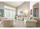 Bright living room showcasing plush seating, shutters, and a glass table for comfortable living at 11651 E Appaloosa Pl, Scottsdale, AZ 85259
