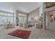 Expansive living room featuring a view into dining room and boasting large windows and neutral color scheme at 11651 E Appaloosa Pl, Scottsdale, AZ 85259
