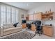 Bright home office features built in cabinetry, a sofa, and a large window at 11651 E Appaloosa Pl, Scottsdale, AZ 85259