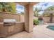 Outdoor kitchen area featuring a built-in grill and nearby seating area at 11651 E Appaloosa Pl, Scottsdale, AZ 85259