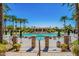 Resort-style pool area framed by palm trees, stone columns, and lush landscaping at 11651 E Appaloosa Pl, Scottsdale, AZ 85259