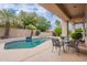 Relaxing backyard featuring a private pool, covered patio, and outdoor seating area at 11651 E Appaloosa Pl, Scottsdale, AZ 85259
