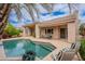 Inviting backyard oasis features a sparkling pool, patio seating, and lush landscaping for outdoor relaxation at 11651 E Appaloosa Pl, Scottsdale, AZ 85259
