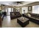 Bright living room featuring a ceiling fan, tile flooring, and a door to the patio at 1209 W Tulane Dr, Tempe, AZ 85283