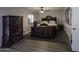 Comfortable main bedroom featuring a ceiling fan, wood-look flooring, a walk-in closet, and a window at 1209 W Tulane Dr, Tempe, AZ 85283