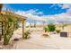 Landscaped backyard with a quaint firepit, lush greenery, and desert accents at 12805 W Colter St, Litchfield Park, AZ 85340