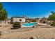 Expansive backyard with a refreshing pool, complemented by low-maintenance desert landscaping and mature trees at 12805 W Colter St, Litchfield Park, AZ 85340