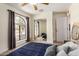 Spare bedroom featuring carpeted floors, ceiling fan, and mirrored closet at 12805 W Colter St, Litchfield Park, AZ 85340
