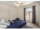 Cozy bedroom featuring carpeted floors, ceiling fan and an arched window at 12805 W Colter St, Litchfield Park, AZ 85340