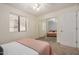 Bedroom featuring carpeted floors, ceiling fan, mirrored closet doors and ample natural light at 12805 W Colter St, Litchfield Park, AZ 85340