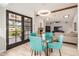 Charming dining area adjacent to the living room, with a glass table and seating for four under stylish lighting at 12805 W Colter St, Litchfield Park, AZ 85340