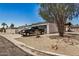 Home exterior showcasing the driveway, a black pickup truck, and desert landscaping at 12805 W Colter St, Litchfield Park, AZ 85340