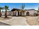 Single-story home with black trim, desert landscape, and a concrete driveway at 12805 W Colter St, Litchfield Park, AZ 85340