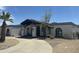 A charming single-story home with a private drive, desert landscaping, and mature palm trees at 12805 W Colter St, Litchfield Park, AZ 85340