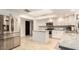 Modern kitchen with stainless steel appliances, bright white cabinets, granite countertops, and an island at 12805 W Colter St, Litchfield Park, AZ 85340