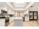 Bright eat-in kitchen featuring stainless steel appliances, skylight, granite countertops, and ample cabinet space at 12805 W Colter St, Litchfield Park, AZ 85340