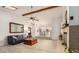 Bright open-concept living area with fireplace, skylight, wood beam, and seamless flow to the kitchen at 12805 W Colter St, Litchfield Park, AZ 85340