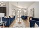 Bright living room with hardwood floors, big windows, a modern chandelier, and blue sofas at 12805 W Colter St, Litchfield Park, AZ 85340