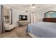 Spacious main bedroom featuring wood floors, ceiling fan, a sitting area and ensuite bathroom at 12805 W Colter St, Litchfield Park, AZ 85340