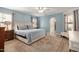 Light and spacious main bedroom with wood floors and a large rug at 12805 W Colter St, Litchfield Park, AZ 85340