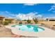 Sparkling pool surrounded by a concrete deck, lush landscaping, and desert views at 12805 W Colter St, Litchfield Park, AZ 85340