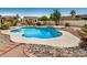 Private backyard featuring a sparkling pool surrounded by desert landscaping, offering a serene outdoor retreat at 12805 W Colter St, Litchfield Park, AZ 85340