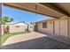 Backyard featuring a large covered patio area with a view of a block wall, plants and desert landscaping at 13608 W Aleppo Dr, Sun City West, AZ 85375