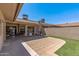Spacious backyard featuring a covered patio, brickwork, and easy access to the home's interior at 13608 W Aleppo Dr, Sun City West, AZ 85375