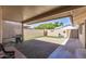 Spacious backyard with a large paved patio and a low-maintenance artificial turf area at 13608 W Aleppo Dr, Sun City West, AZ 85375