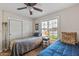 Bedroom features two beds, bright windows, and a ceiling fan, providing a comfortable retreat at 13608 W Aleppo Dr, Sun City West, AZ 85375