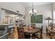 The dining room features a rustic table with chairs, a modern chandelier, and a view into the kitchen at 13608 W Aleppo Dr, Sun City West, AZ 85375