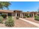Charming home with desert landscaping, including gravel, shrubs, and a paved walkway leading to the front door at 13608 W Aleppo Dr, Sun City West, AZ 85375