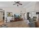Comfortable living area with wood-look floors, a vaulted ceiling, and access to a screened-in patio at 13608 W Aleppo Dr, Sun City West, AZ 85375