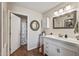 Bright main bathroom with wooden floors, cabinets and a mirror over the sink at 13608 W Aleppo Dr, Sun City West, AZ 85375