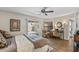 Comfortable main bedroom with wood floors, ceiling fan, desk, and patio door at 13608 W Aleppo Dr, Sun City West, AZ 85375