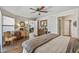 Comfortable main bedroom with wood floors, ceiling fan and doorway access to other rooms at 13608 W Aleppo Dr, Sun City West, AZ 85375