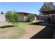 Backyard features two outbuildings in the distance and a covered patio at 14439 N 38Th Pl, Phoenix, AZ 85032