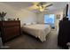 Cozy bedroom with a comfortable bed, ceiling fan, and natural light from the window at 14439 N 38Th Pl, Phoenix, AZ 85032