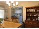 Dining room leading into the laundry room, with views of a wooden cabinet for storage at 14439 N 38Th Pl, Phoenix, AZ 85032
