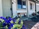 Inviting front porch with lovely flowers and a wooden bench at 14439 N 38Th Pl, Phoenix, AZ 85032