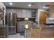 A well-lit kitchen featuring stainless steel appliances, gray cabinetry and decorative backsplash at 14439 N 38Th Pl, Phoenix, AZ 85032