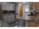 Modern kitchen with gray cabinets, a gas cooktop, neutral backsplash, and stainless steel appliances at 14439 N 38Th Pl, Phoenix, AZ 85032
