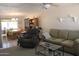 Cozy living room featuring plush sofa and recliner with a view into the dining area at 14439 N 38Th Pl, Phoenix, AZ 85032
