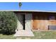 Open barn doors with adjacent shrubbery and an American flag hanging on the side at 14439 N 38Th Pl, Phoenix, AZ 85032
