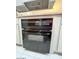 The built in oven has white wood cabinets and black features at 14439 N 38Th Pl, Phoenix, AZ 85032