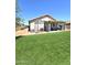 An expansive, fenced backyard with artificial grass and covered patio at 15023 W Redfield Rd, Surprise, AZ 85379